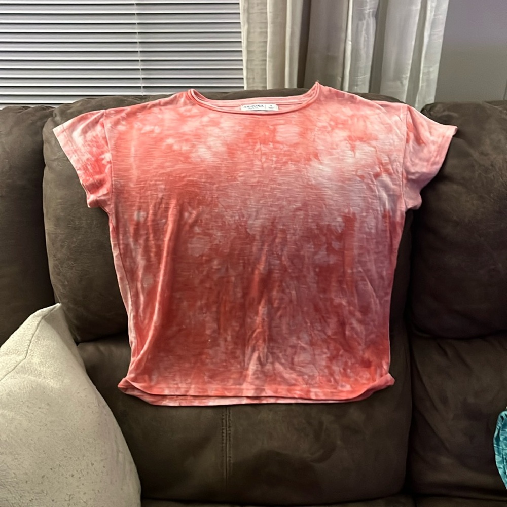 A tie-dyed pinkish white top